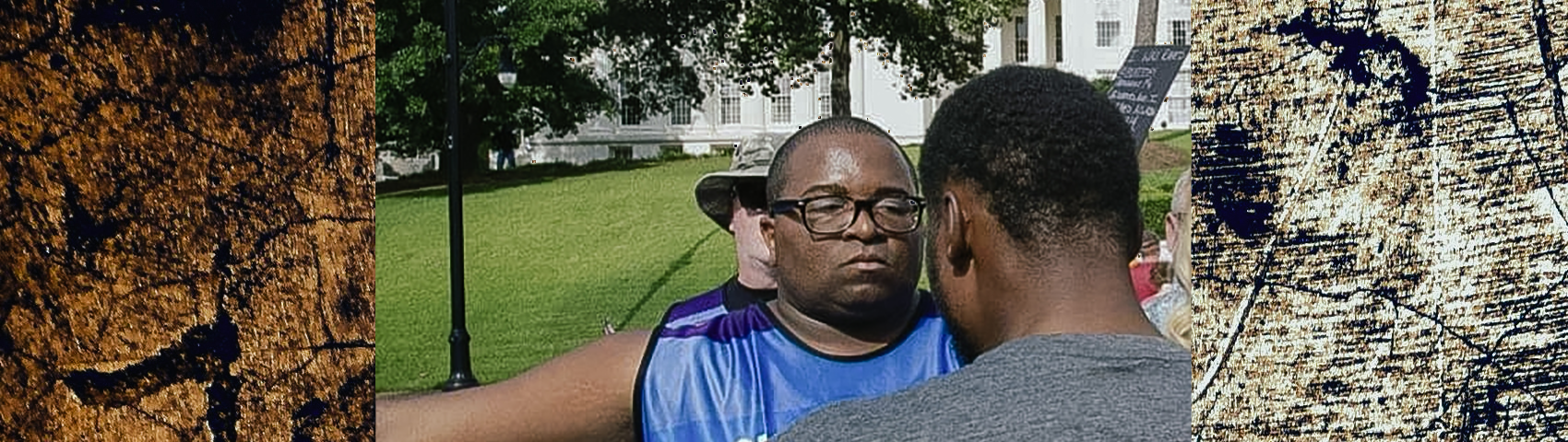 A man wearing glasses and a clinic escort vest standing outside in front of a large building, engaging with another person whose back is to the camera. The background includes trees and people in the distance. The sides of the image have a textured, grungy overlay.